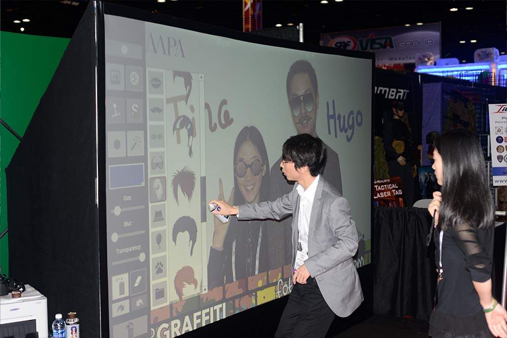 Guests interacting with an MMI Events Live activation on a busy trade show floor